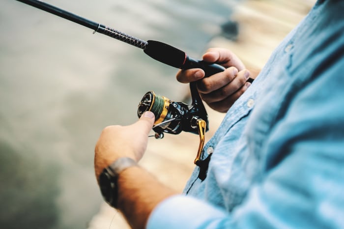 Fishing rod and reel in anglers hand